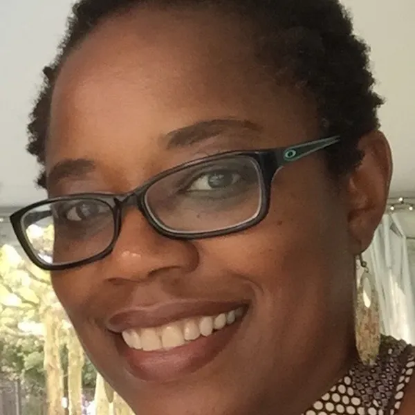 Photo of Candace White (woman with glasses and short black hair)