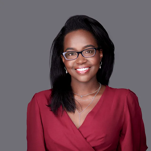 Photo of Ariel Fleurimond, woman with black hair and glasses.