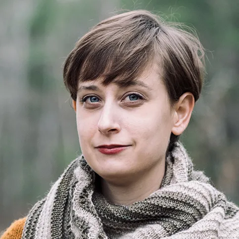 Photo of Jennie Johnson, a woman with short brown hair and a knitted shawl.