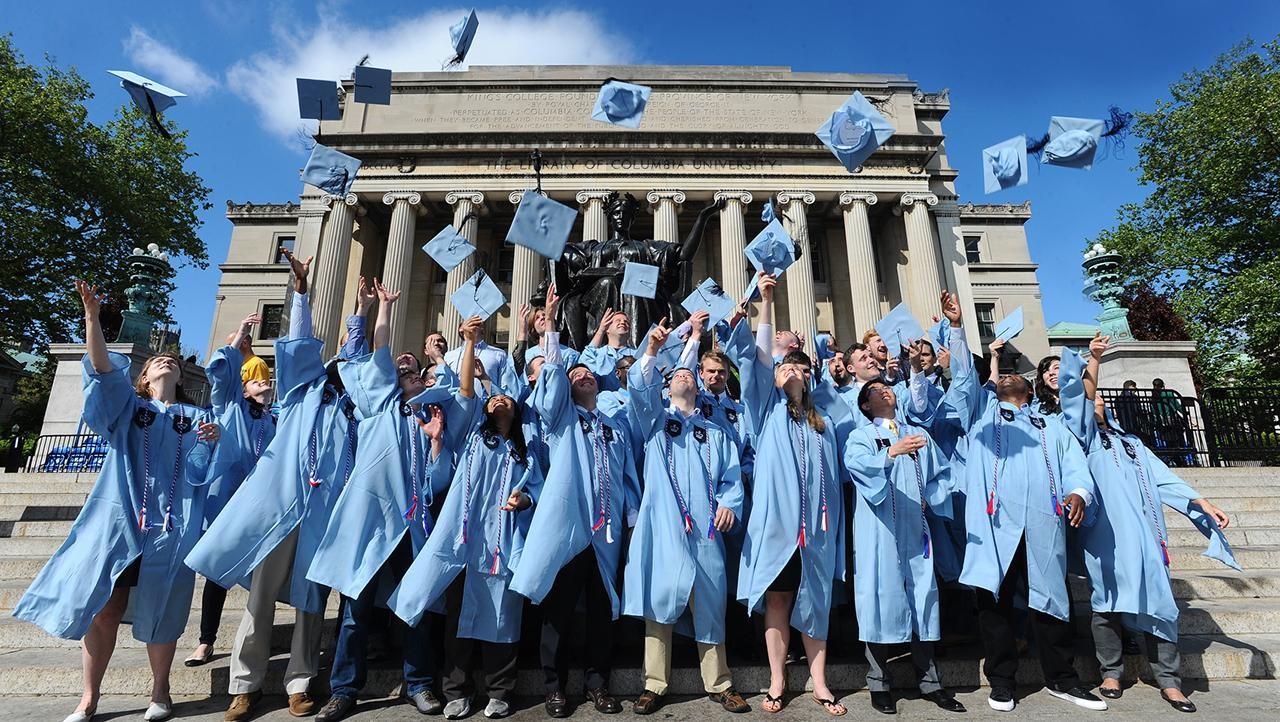 Graduates throwing their caps up in the air