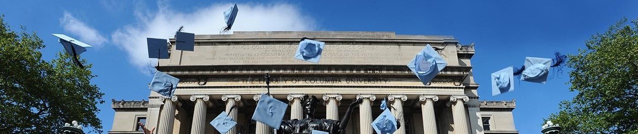 Blue graduation caps in the air in front of Low Library